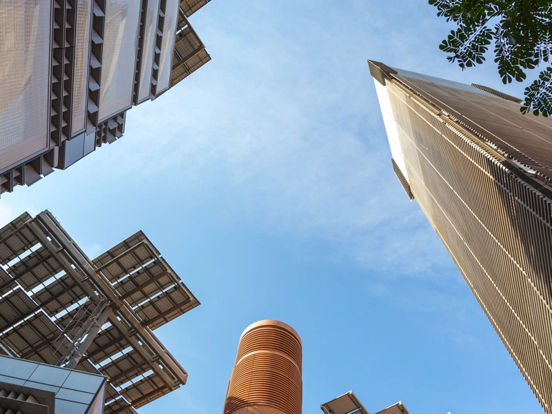 Upwards view of skyscraper buildings and blue sky