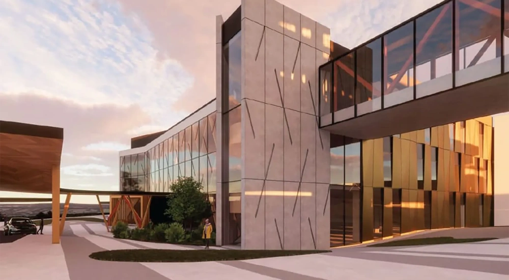 Modern hospital exterior with glass facade at dusk.