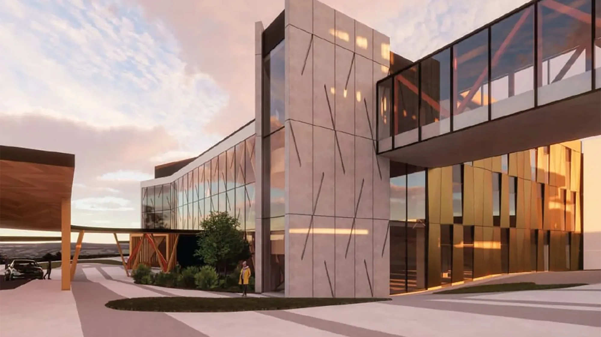 Modern hospital exterior with glass facade at dusk.